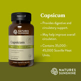 Natures Sunshine Capsicum herbal supplement bottle on a yellow-green background with text describing benefits and Scoville heat units.