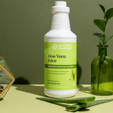 Nature's Sunshine Aloe Vera Juice bottle on a green background with aloe vera leaves.