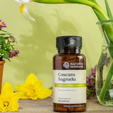 Nature's Sunshine Cascara Sagrada supplement bottle with flowers in the background