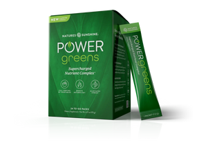 Nature's Sunshine Power Greens dietary supplement box in green, with one single-serve packet standing beside it on a clean white background.
