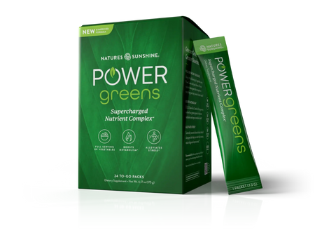Nature's Sunshine Power Greens dietary supplement box in green, with one single-serve packet standing beside it on a clean white background.