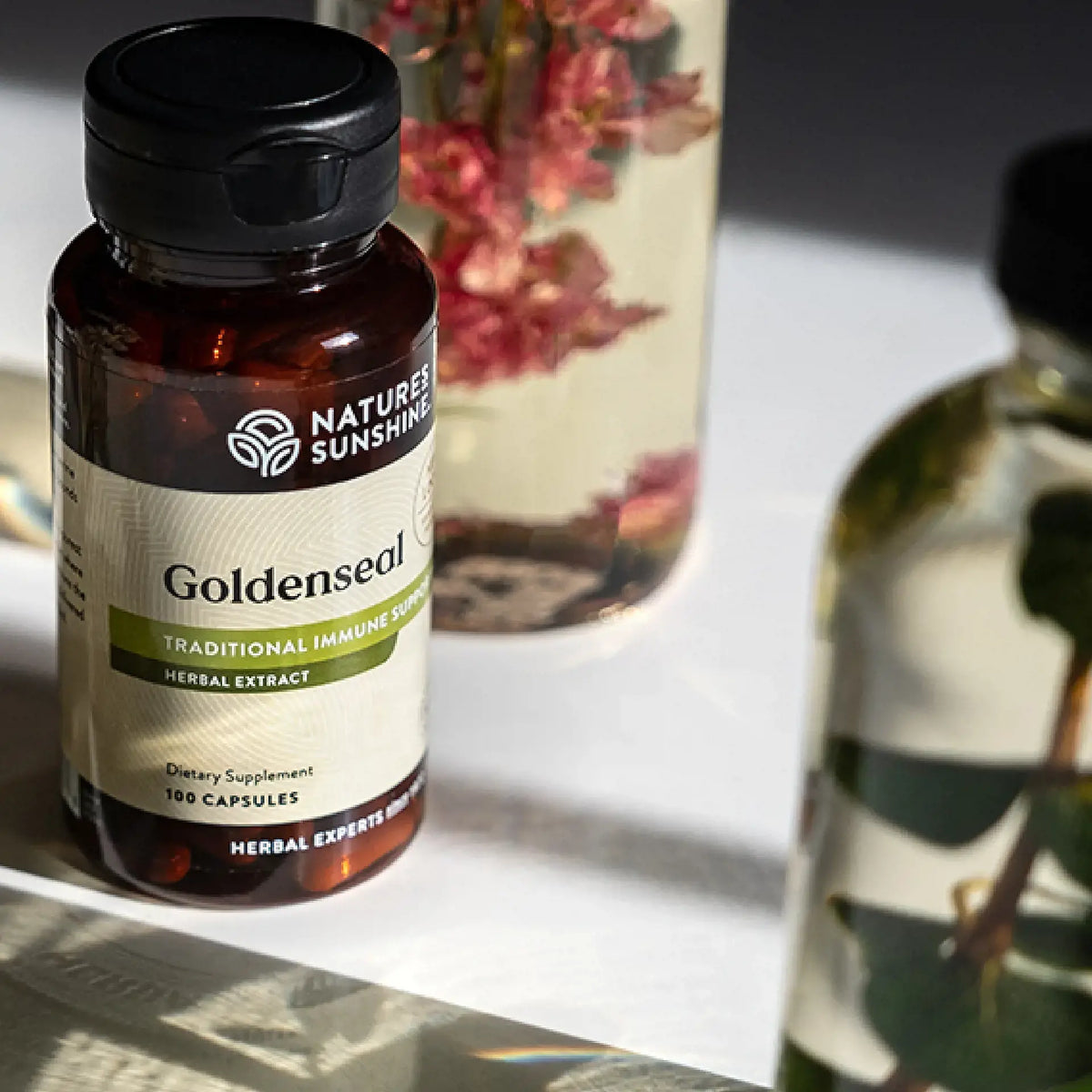 Nature's Sunshine Goldenseal supplement bottle on a surface with a blurred background