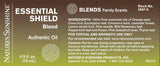 A rectangular product label for Nature's Sunshine ESSENTIAL SHIELD Blend authentic oil, showing blend details, ingredients, and usage information on a brown-to-black gradient background.