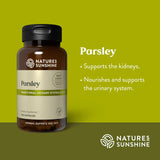 A bottle of Natures Sunshine Parsley dietary supplement on a green background with text describing its benefits for the kidneys and urinary system.