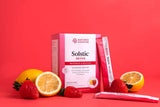 Nature's Sunshine Solstic Revive nutritional drink mix box and sachets arranged with strawberries, lemons, and orange slices on a solid red background.