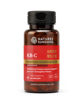 A bottle of Nature's Sunshine KB-C Traditional Chinese Medicine dietary supplement, featuring a dark amber bottle, black cap, and a red label with gold and white text.