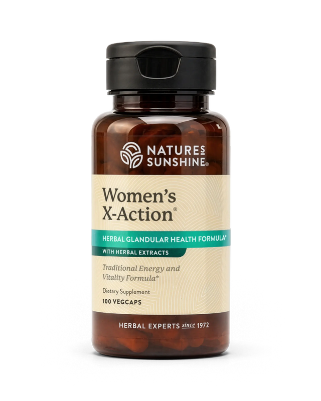A bottle of Nature's Sunshine Women's X-Action herbal dietary supplement, featuring an amber glass bottle with a black cap and a beige label with green and white text.