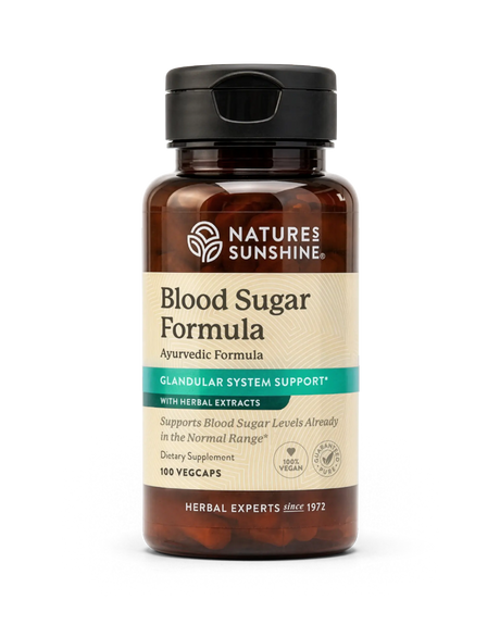 A bottle of Nature's Sunshine Blood Sugar Formula dietary supplement, featuring amber brown glass, a black cap, and a beige label with teal accents, set against a plain white background.