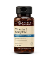 Nature's Sunshine Vitamin E Complete dietary supplement bottle with a black cap and amber brown glass, on a white background.