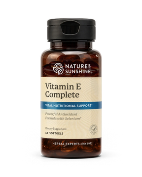 Nature's Sunshine Vitamin E Complete dietary supplement bottle with a black cap and amber brown glass, on a white background.