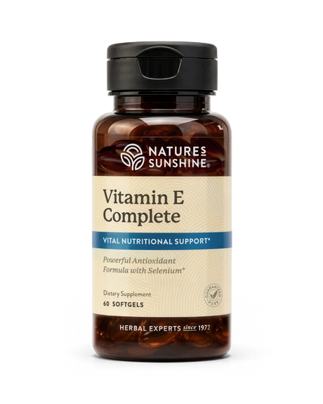 Nature's Sunshine Vitamin E Complete dietary supplement bottle with a black cap and amber brown glass, on a white background.