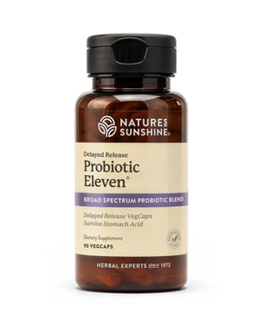 A bottle of Nature's Sunshine Probiotic Eleven dietary supplement, featuring an amber brown bottle, a black cap, and a beige label with purple accents, set against a plain white background.