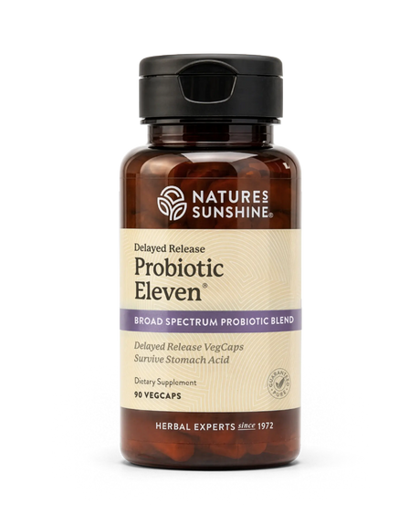 A bottle of Nature's Sunshine Probiotic Eleven dietary supplement, featuring an amber brown bottle, a black cap, and a beige label with purple accents, set against a plain white background.