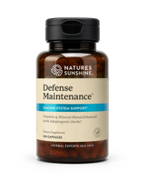 A bottle of Nature's Sunshine Defense Maintenance dietary supplement, featuring an amber brown bottle, a black cap, and a beige label with a blue accent stripe.