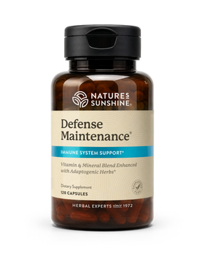 A bottle of Nature's Sunshine Defense Maintenance dietary supplement, featuring an amber brown bottle, a black cap, and a beige label with a blue accent stripe.