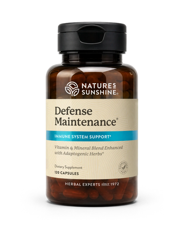 A bottle of Nature's Sunshine Defense Maintenance dietary supplement, featuring an amber brown bottle, a black cap, and a beige label with a blue accent stripe.