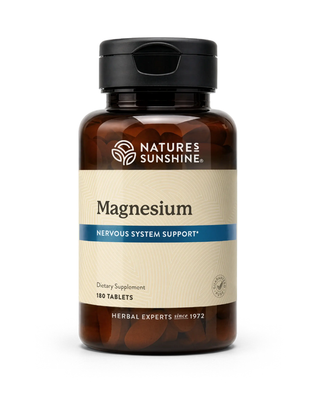 A bottle of Nature's Sunshine Magnesium dietary supplement with 180 tablets, featuring an amber brown bottle, black cap, and a beige label with a blue accent stripe.