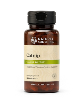 A bottle of Natures Sunshine Catnip dietary supplement with a black cap and amber-brown bottle, featuring a beige and green label, on a white background.