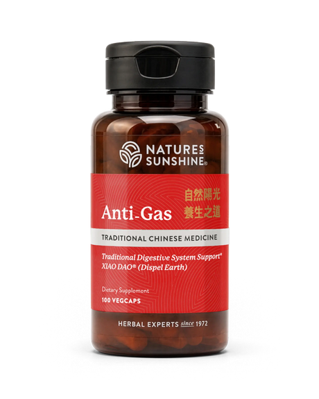 A bottle of Nature's Sunshine Anti-Gas dietary supplement, featuring a dark amber glass bottle, a black cap, and a red label with white and gold text.