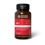 A bottle of Natures Sunshine KB-C Traditional Chinese Medicine dietary supplement, featuring a dark amber brown bottle, a black cap, and a label with red, white, and silver sections.