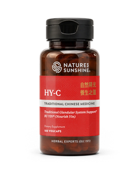 A bottle of Natures Sunshine HY-C Traditional Chinese Medicine dietary supplement, featuring a dark amber bottle, black cap, and a red label with white and gold text.