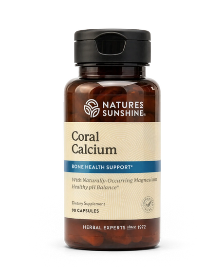 A bottle of Nature's Sunshine Coral Calcium dietary supplement, featuring an amber brown bottle, a black cap, and a beige label with blue accents.