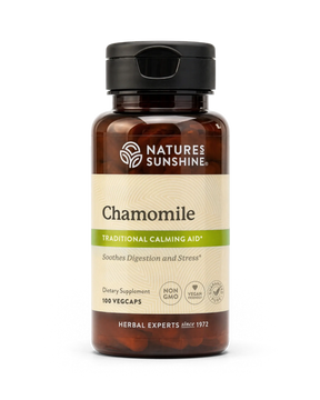 A bottle of Nature's Sunshine Chamomile dietary supplement with amber brown plastic, a black cap, and a beige label with green accents, shown on a white background.