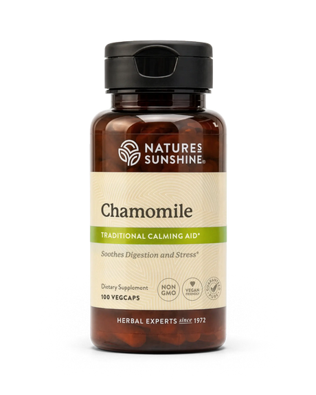A bottle of Nature's Sunshine Chamomile dietary supplement with amber brown plastic, a black cap, and a beige label with green accents, shown on a white background.