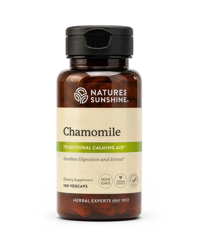 A bottle of Nature's Sunshine Chamomile dietary supplement with amber brown plastic, a black cap, and a beige label with green accents, shown on a white background.