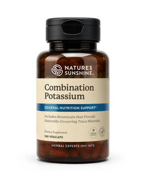 A bottle of Nature's Sunshine Combination Potassium dietary supplement, featuring an amber brown bottle, black cap, and a beige label with blue accents, containing 180 vegcaps.