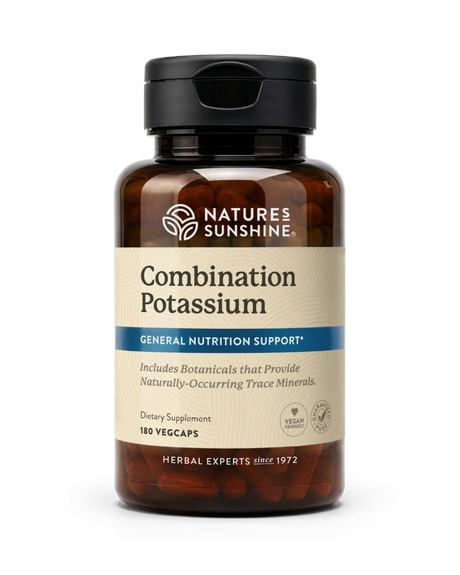 A bottle of Nature's Sunshine Combination Potassium dietary supplement, featuring an amber brown bottle, black cap, and a beige label with blue accents, containing 180 vegcaps.