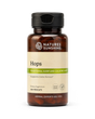 A bottle of Nature's Sunshine Hops dietary supplement with a black cap and amber-brown bottle, featuring a beige label with green accents, on a white background.
