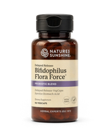 A bottle of Nature's Sunshine Bifidophilus Flora Force probiotic supplement, featuring amber brown plastic, a black cap, and a beige label with purple accents, set against a plain white background.
