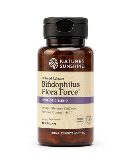 A bottle of Nature's Sunshine Bifidophilus Flora Force probiotic supplement, featuring amber brown plastic, a black cap, and a beige label with purple accents, set against a plain white background.