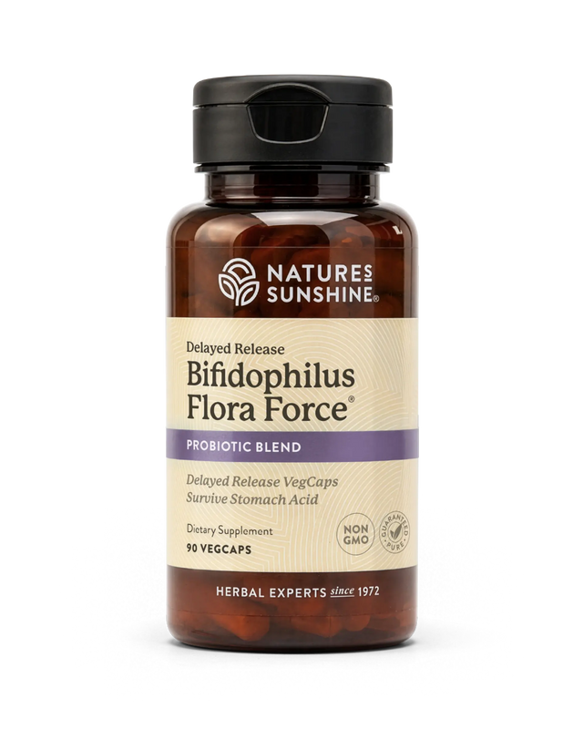 A bottle of Nature's Sunshine Bifidophilus Flora Force probiotic supplement, featuring amber brown plastic, a black cap, and a beige label with purple accents, set against a plain white background.