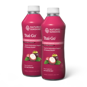 Two bottles of Nature's Sunshine Thai-Go dietary supplement, featuring a deep magenta label with white caps and illustrations of mangosteen fruit and leaves.