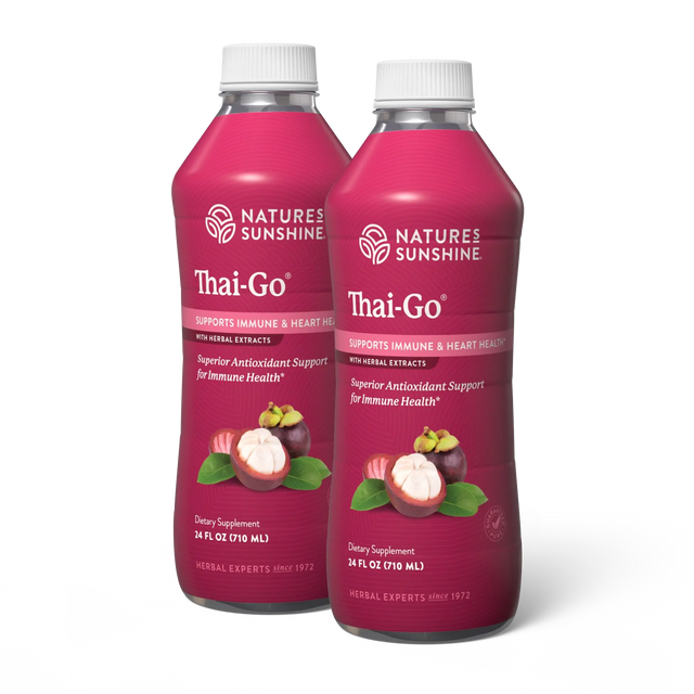 Two bottles of Nature's Sunshine Thai-Go dietary supplement, featuring a deep magenta label with white caps and illustrations of mangosteen fruit and leaves.