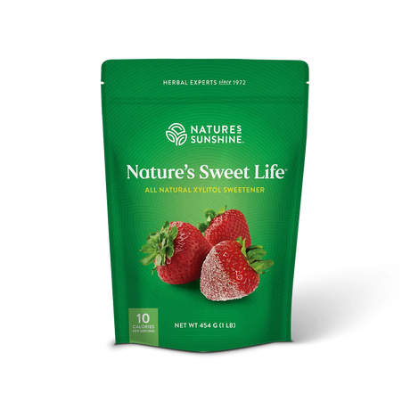A green stand-up pouch of Nature's Sweet Life herbal xylitol sweetener by Nature's Sunshine, featuring an illustration of three strawberries on the front, set against a plain white background.