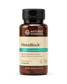 A bottle of Nature's Sunshine HistaBlock dietary supplement with a black cap and amber-brown bottle, featuring a beige and teal label, on a white background.