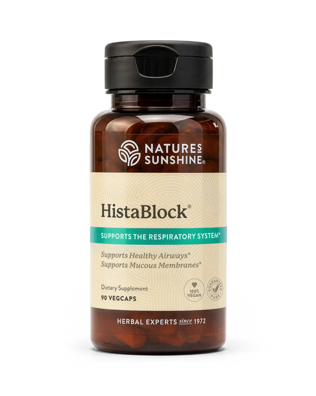 A bottle of Nature's Sunshine HistaBlock dietary supplement with a black cap and amber-brown bottle, featuring a beige and teal label, on a white background.