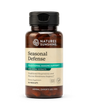 A bottle of Nature's Sunshine Seasonal Defense dietary supplement with amber brown plastic, a black cap, and a beige label with green and teal accents, shown on a white background.