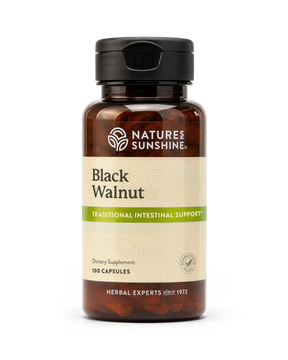 A bottle of Nature's Sunshine Black Walnut dietary supplement capsules, featuring an amber brown bottle, black cap, and a beige label with green accents.