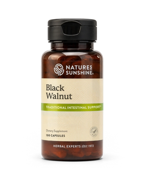 A bottle of Nature's Sunshine Black Walnut dietary supplement capsules, featuring an amber brown bottle, black cap, and a beige label with green accents.