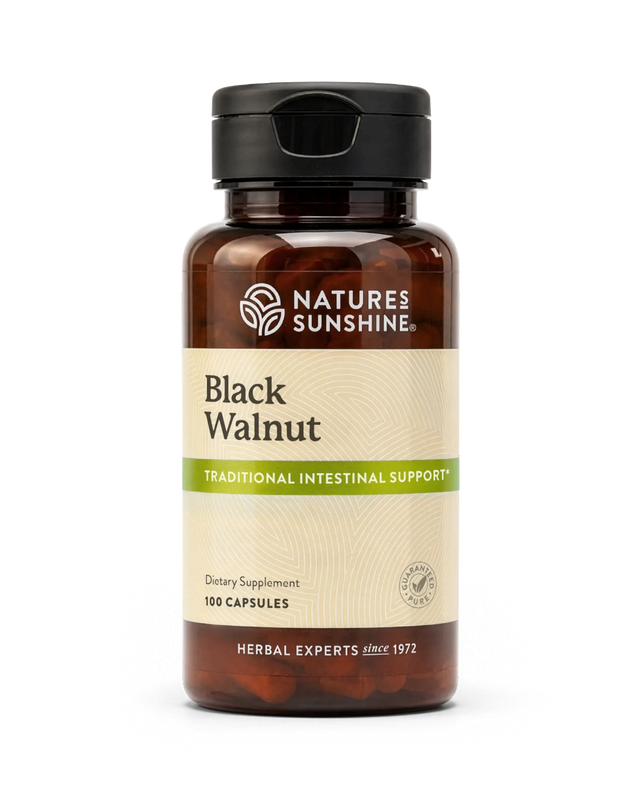 A bottle of Nature's Sunshine Black Walnut dietary supplement capsules, featuring an amber brown bottle, black cap, and a beige label with green accents.