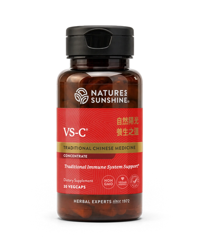 A bottle of Natures Sunshine VS-C Traditional Chinese Medicine dietary supplement, featuring a dark amber brown bottle, a black flip-top cap, and a red label with gold and white text.