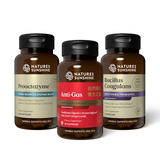 Three amber supplement bottles from Nature's Sunshine on a white background: Proactzyme on the left, Anti-Gas in the center with a red label, and Bacillus Coagulans on the right.